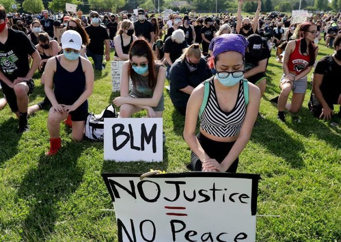 Demonstrators get down on their knee as they take moment of silence for George Floyd during a Black Lives Matter protest at the Buffalo Grove park District???s Spray ???N??? Play in Buffalo Grove, Ill., Thursday, June 4, 2020. (AP Photo/Nam Y. Huh)