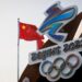 The Chinese national flag flies behind the logo of the Beijing 2022 Winter Olympics in Beijing, China, January 14, 2022. REUTERS/Thomas Peter