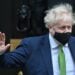 Britain's Prime Minister Boris Johnson, wearing a face covering to help mitigate the spread of coronavirus, waves as he leaves from 10 Downing Street in central London on January 19, 2022, to take part in the weekly session of Prime Minister Questions (PMQs) at the House of Commons. - British Prime Minister Boris Johnson on Wednesday faced signs of an organised revolt in his Conservative party over revelations of lockdown-breaching parties, as he geared up for a grilling in parliament. (Photo by JUSTIN TALLIS / AFP) (Photo by JUSTIN TALLIS/AFP via Getty Images)