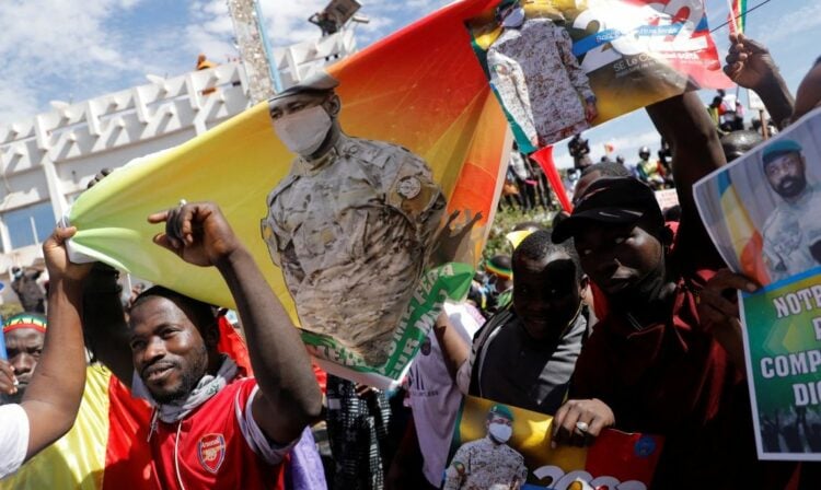Supporters hold a poster of Mali's transition president, Colonel Assimi Goita, as they participate in a demonstration called by Mali transitional government after ECOWAS (Economic Community of West African States) sanctions in Bamako, Mali, January 14, 2022. REUTERS/Paul Lorgerie - RC22ZR9OC0V7