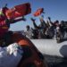 Migrants from Africa sailing adrift on an overcrowded rubber boat, receive life jackets from aid workers of the Spanish NGO Aita Mary in the Mediterranean Sea, about 103 miles (165 kms.) from Libya coast on Friday Jan. 28, 2022. (AP Photo/Pau de la Calle)