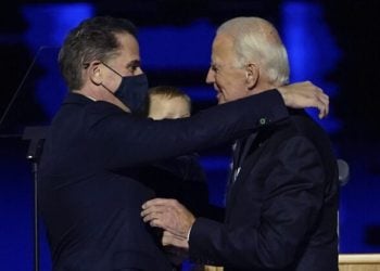 FILE - In this Nov. 7, 2020, file photo, President-elect Joe Biden, right, embraces his son Hunter Biden, left, in Wilmington, Del. Biden’s son Hunter says he has learned from federal prosecutors that his tax affairs are under investigation.  (AP Photo/Andrew Harnik, Pool)