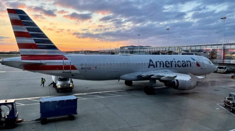 An American Airlines plane is seen at sunrise parked on the tarmac of the Reagan Washington National Airport (DCA) in Arlington, Virginia, on April 22, 2021. - American Airlines reported another quarterly loss Thursday as Covid-19 continued to depress travel, but expressed optimism at an industry recovery with vaccinations becoming more widespread. (Photo by Daniel SLIM / AFP) (Photo by DANIEL SLIM/AFP via Getty Images)