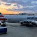 An American Airlines plane is seen at sunrise parked on the tarmac of the Reagan Washington National Airport (DCA) in Arlington, Virginia, on April 22, 2021. - American Airlines reported another quarterly loss Thursday as Covid-19 continued to depress travel, but expressed optimism at an industry recovery with vaccinations becoming more widespread. (Photo by Daniel SLIM / AFP) (Photo by DANIEL SLIM/AFP via Getty Images)