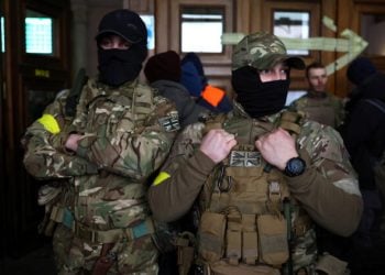 Two foreign fighters from the UK asked to be identified as "Scouser" and "Jacks" pose for a picture as they are ready to depart towards the front line in the east of Ukraine following the Russian invasion, at the main train station in Lviv, Ukraine, March 5, 2022. REUTERS/Kai Pfaffenbach