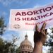 A supporter of reproductive rights holds a sign outside the Texas State Capitol building during the nationwide Women's March, held after Texas rolled out a near-total ban on abortion procedures and access to abortion-inducing medications, in Austin, Texas, U.S. October 2, 2021. Picture taken October 2, 2021. REUTERS/Evelyn Hockstein