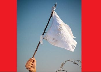 Arm holding white flag on the battlefield
