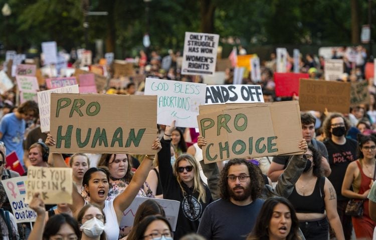 Demonstrators hold "Pro Human" and "Pro Choice" signs as they march in the streets to protest the overturning of Roe Vs. Wade by the Supreme Court in Boston, Massachusetts on June 24, 2022. (Photo by Joseph Prezioso / AFP)