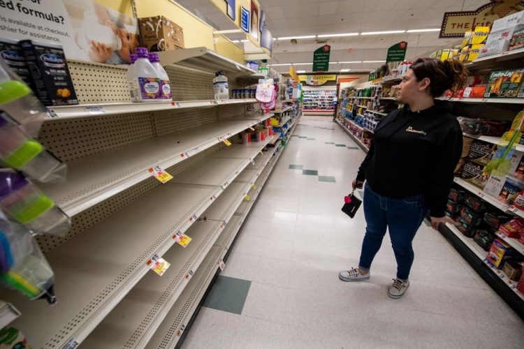 Shelves are empty as Natalia Restrepo, 29, a member of La Colaborativa, gathers formula supplies for the up-coming pantry openings in Chelsea, Massachusetts on May 20, 2022. - The US government will fly in baby formula on commercial planes contracted by the military in an airlift aimed at easing the major shortage plaguing the country, the White House said on May 18, 2022. (Photo by Joseph Prezioso / AFP) (Photo by JOSEPH PREZIOSO/AFP via Getty Images)
