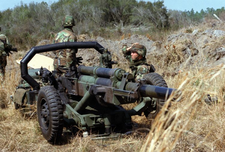 A gun crew from the 82nd Airborne Division prepares an M102 105 mm howitzer as they make the gun ready for a fire mission during Exercise SAND EAGLE '89.