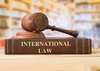 International Law book with a judges gavel on desk in the library. Law education ,law books ,international law concept. Sharing agreement applicable to international relations.