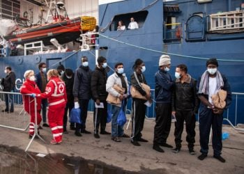 SALERNO, ITALY - DECEMBER 11: Migrants during the disembarking operations from the ship Geo Barents on December 11, 2022 in Salerno, Italy. 248 migrants rescued by the Geo Barents ship of the NGO Doctors Without Borders landed in the port of Salerno in the southern Mediterranean Sea. Among the landed migrants there are 84 minors, 78 of whom are unaccompanied who will be welcomed in the structures of Salerno and Taranto. (Photo by Ivan Romano/Getty Images)