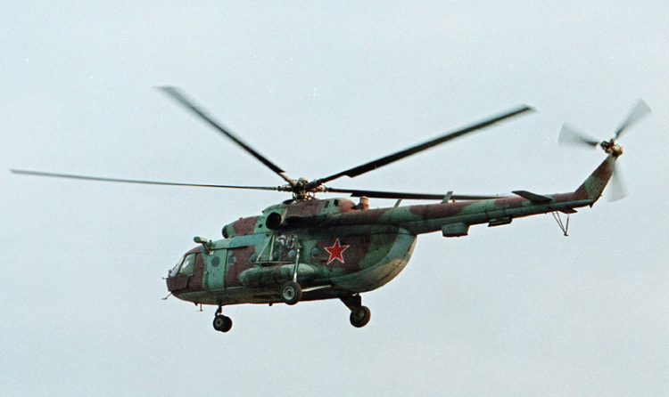 FILE In this in this Sept. 18, 2002 file photo a Mi-8 helicopter flies over the Chechen regional capital Grozny, Russia. A helicopter similar to the one pictured has been shot down in Syria and Russian President Vladimir Putin's spokesman says all people aboard it have been killed, Monday, Aug. 1, 2016. (AP Photo/Musa Sadulayev, File)