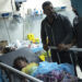 Relatives stand next to a child wounded in the Israeli bombardment of the Gaza Strip in a hospital in Khan Younis, Tuesday, Oct. 17, 2023. (AP Photo/Fatima Shbair)