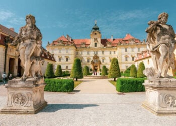 Valtice, Lednice, Moravia, Czech Republic; June 17, 2018: Frontyard and  a renaissance facade of the Valtice castle with formal garden and sightseeing tourists