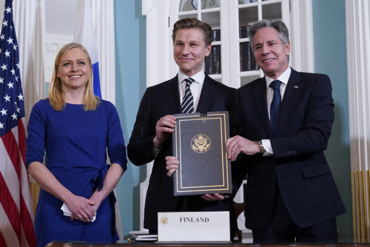 Secretary of State Antony Blinken, right, and Finland's Defense Minister Antti Häkkänen, center, pose for a photo after signing a Defense Cooperation Agreement as Finland's Foreign Minister Elina Valtonen joins at left at the State Department in Washington, Monday, Dec. 18, 2023. (AP Photo/Susan Walsh)