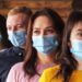 Crowd of young people wearing masks on their faces during the coronavirus pandemic - New normal masked millennials - New concept of normal life