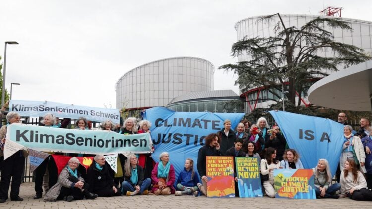 Protesters hold placards during a rally before the European Court of Human Rights (ECHR) decides in three separate cases if states are doing enough in the face of global warming in rulings that could force them to do more, in Strasbourg, eastern France, on April 9, 2024. All three cases accuse European governments of inaction or insufficient action in their measures against global warming. In a sign of the importance of the issue, the cases have all been treated as priority by the Grand Chamber of the ECHR, whose 17 judges can set a potentially crucial legal precedent. (Photo by Frederick FLORIN / AFP) (Photo by FREDERICK FLORIN/AFP via Getty Images)