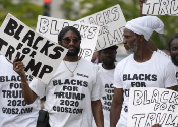 WASHINGTON, DC - AUGUST 03: Black supporters of former U.S. President Donald Trump carry signs in front of the E. Barrett Prettyman United States Courthouse on August 03, 2023 in Washington, DC. Former U.S. President Donald Trump is scheduled to be arraigned this afternoon after being indicted on four felony counts for his alleged efforts to overturn the 2020 election. (Photo by Kent Nishimura/Getty Images)