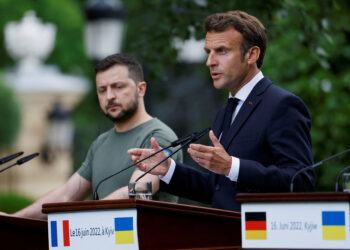 FILE PHOTO: French President Emmanuel Macron speaks as Ukrainian President Volodymyr Zelenskiy listens during a joint news conference, as Russia's attack on Ukraine continues, in Kyiv, Ukraine June 16, 2022.  REUTERS/Valentyn Ogirenko/File Photo