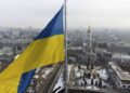 FILE - A Ukrainian national flag waves over the center of Kharkiv, Ukraine's second-largest city, Feb. 16, 2022.  U.S. officials say Ukraine for the first time has begun using long-range ballistic missiles, striking a Russian military airfield in Crimea and Russian troops in another occupied area overnight.  (AP Photo/Mstyslav Chernov, File)