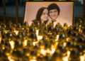 Light tributes placed during a silent protest in memory of murdered journalist Jan Kuciak and his girlfriend Martina Kusnirova, seen in photo, in Bratislava, Slovakia, on Wednesday, Feb. 28, 2018.  Investigative journalist Kuciak was shot dead in Slovakia last week while working on a story about the activities of Italian mafia in Slovakia and their alleged links to people close to Prime Minister Robert Fico.(AP Photo/Bundas Engler)